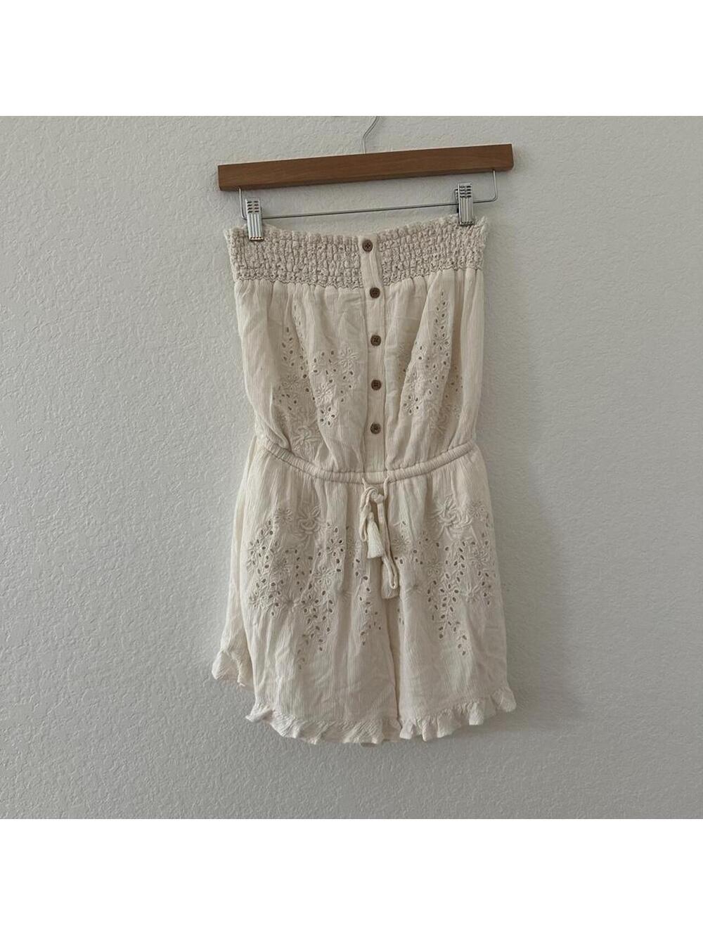 American Eagle cream romper with button-up front and tie waist.